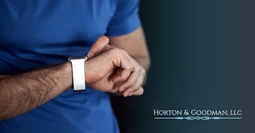 Man looking down at wristwatch.